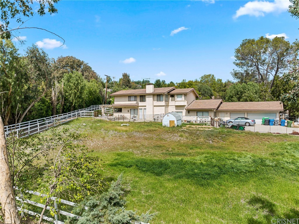 24862 Eldorado Meadow Road Hidden Hills, CA 91302 - Photo 11 of 16 a view of a large pool with lawn chairs under an umbrella