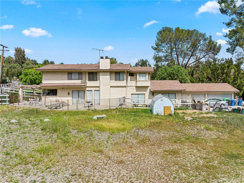 24862 Eldorado Meadow Road Hidden Hills, CA 91302 - Photo 12 of 16 a view of a house with a big yard and potted plants