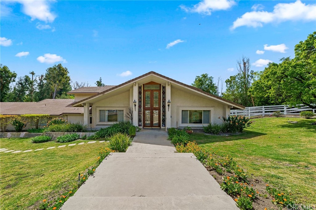 24862 Eldorado Meadow Road Hidden Hills, CA 91302 - Photo 2 of 16 a front view of a house with garden