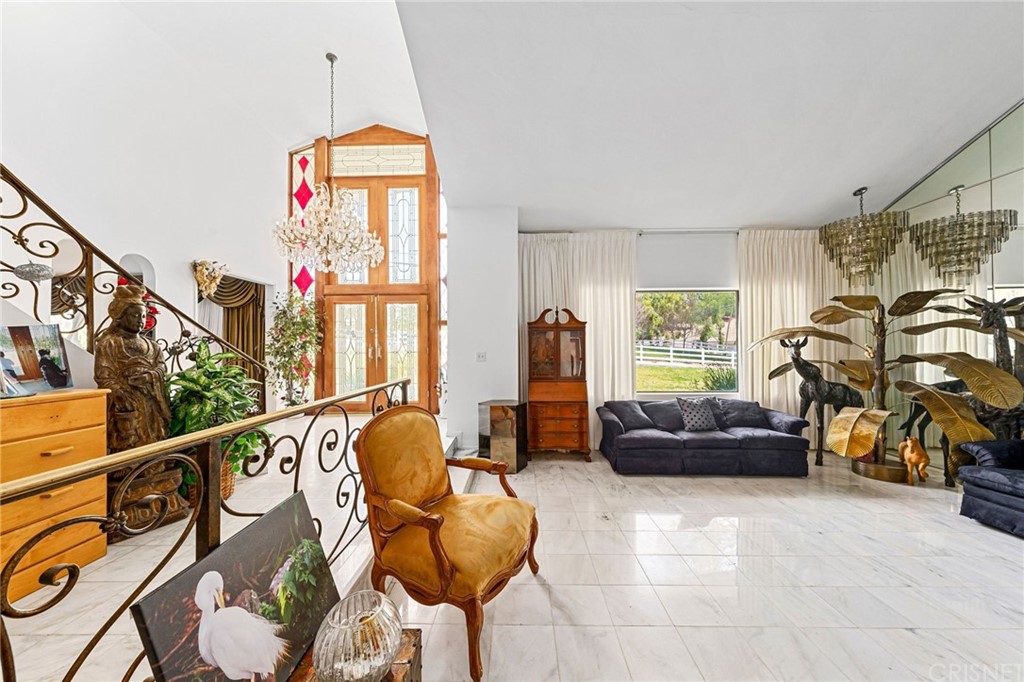24862 Eldorado Meadow Road Hidden Hills, CA 91302 - Photo 7 of 16 a living room with furniture a couch and a chandelier