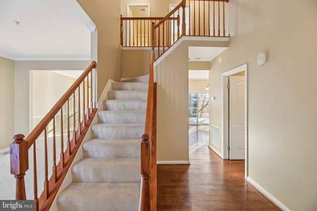 a view of staircase with wooden floor and a large window