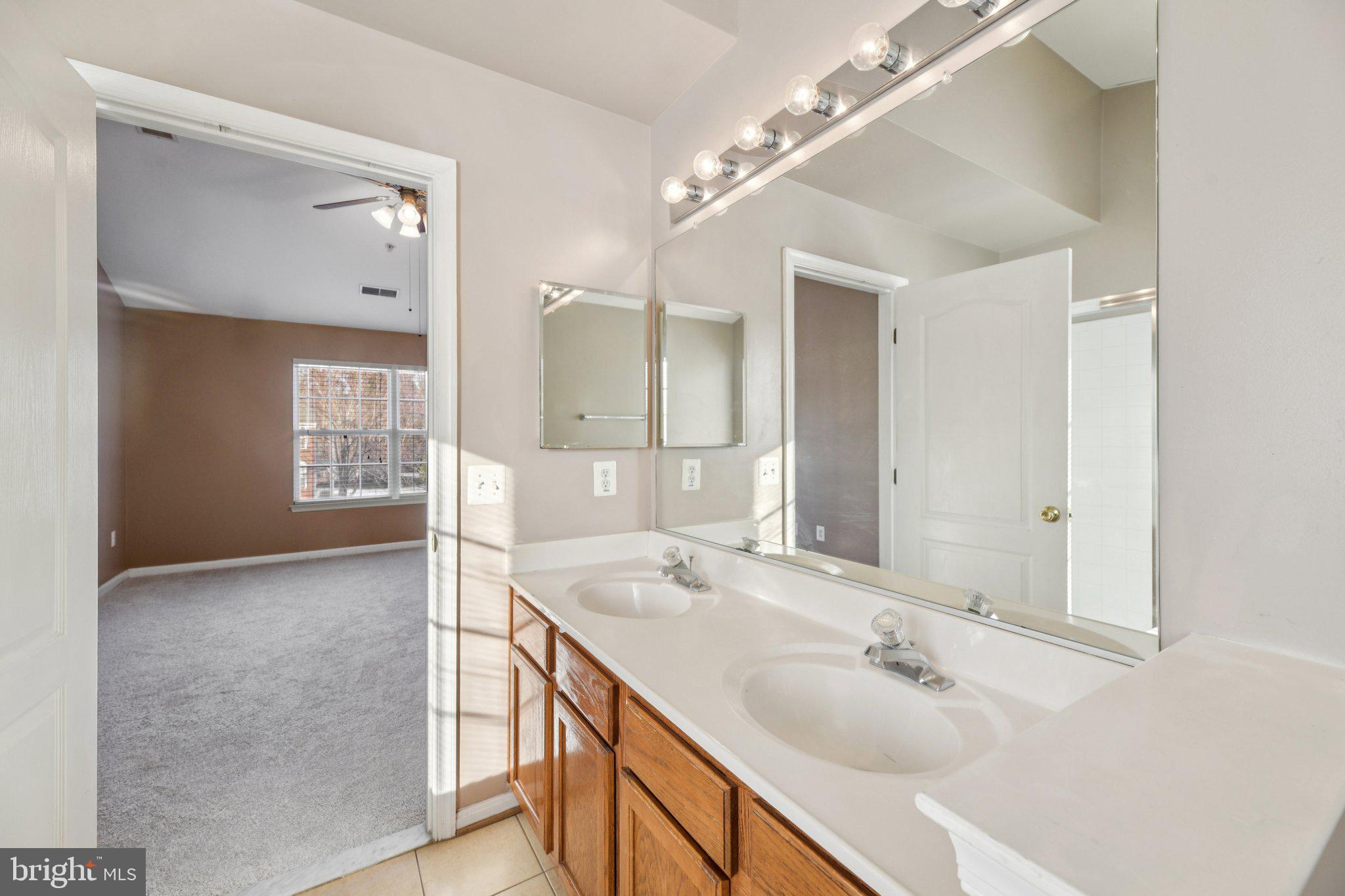 14505 Pleffner Court Bowie, MD 20720 - Photo 17 of 41 a bathroom with a double vanity sink and a mirror