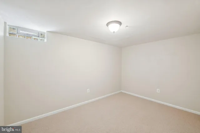 a view of empty room with white walls and door