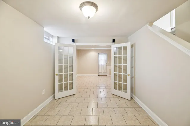 a utility room with a sink a vanity and a window