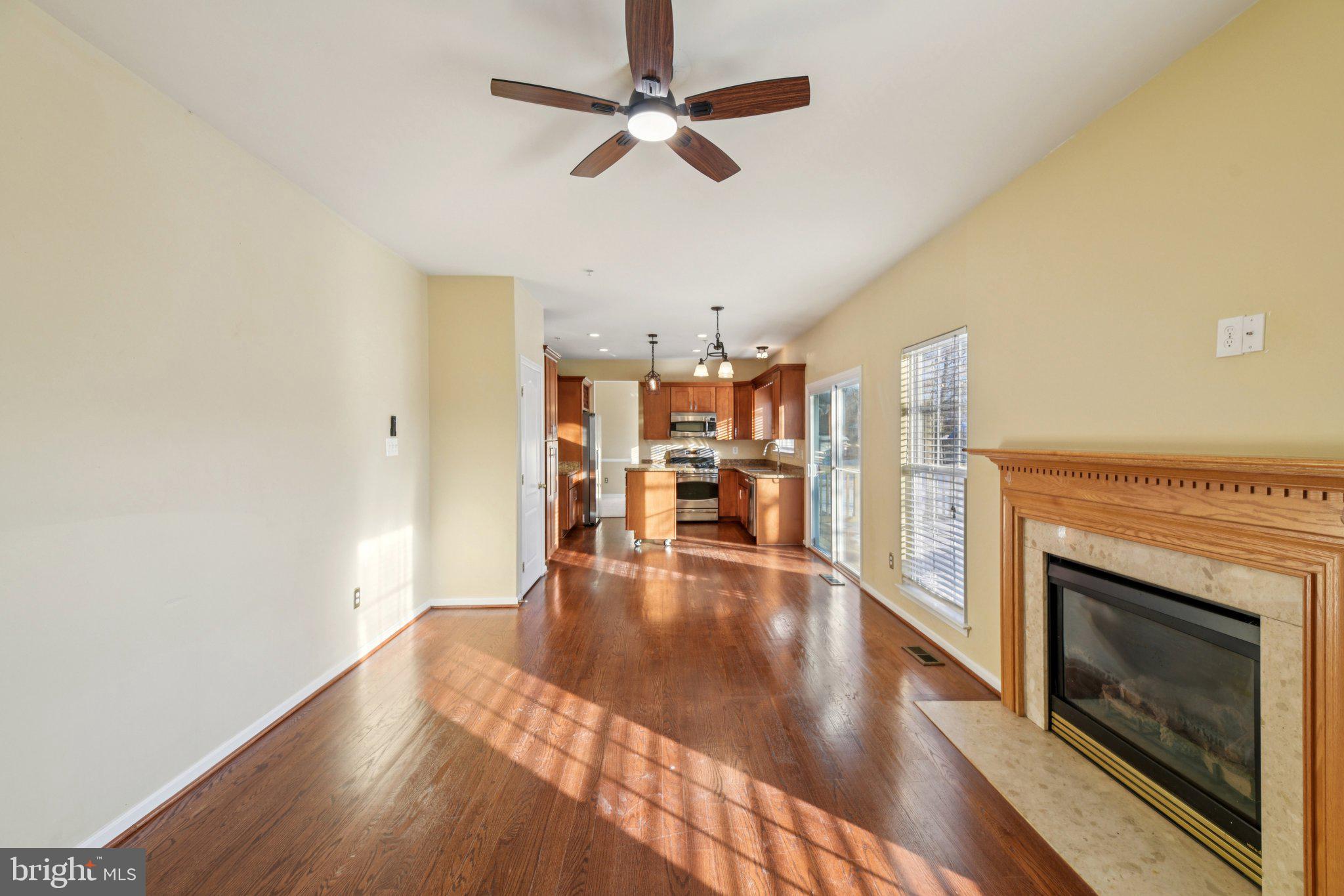 14505 Pleffner Court Bowie, MD 20720 - Photo 6 of 41 a view of a livingroom with wooden floor a ceiling fan and staircase