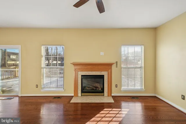 a view of an empty room with exposed radiator and fireplace