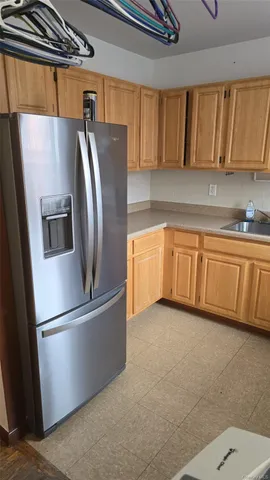 a kitchen with stainless steel appliances granite countertop a refrigerator a sink and a stove