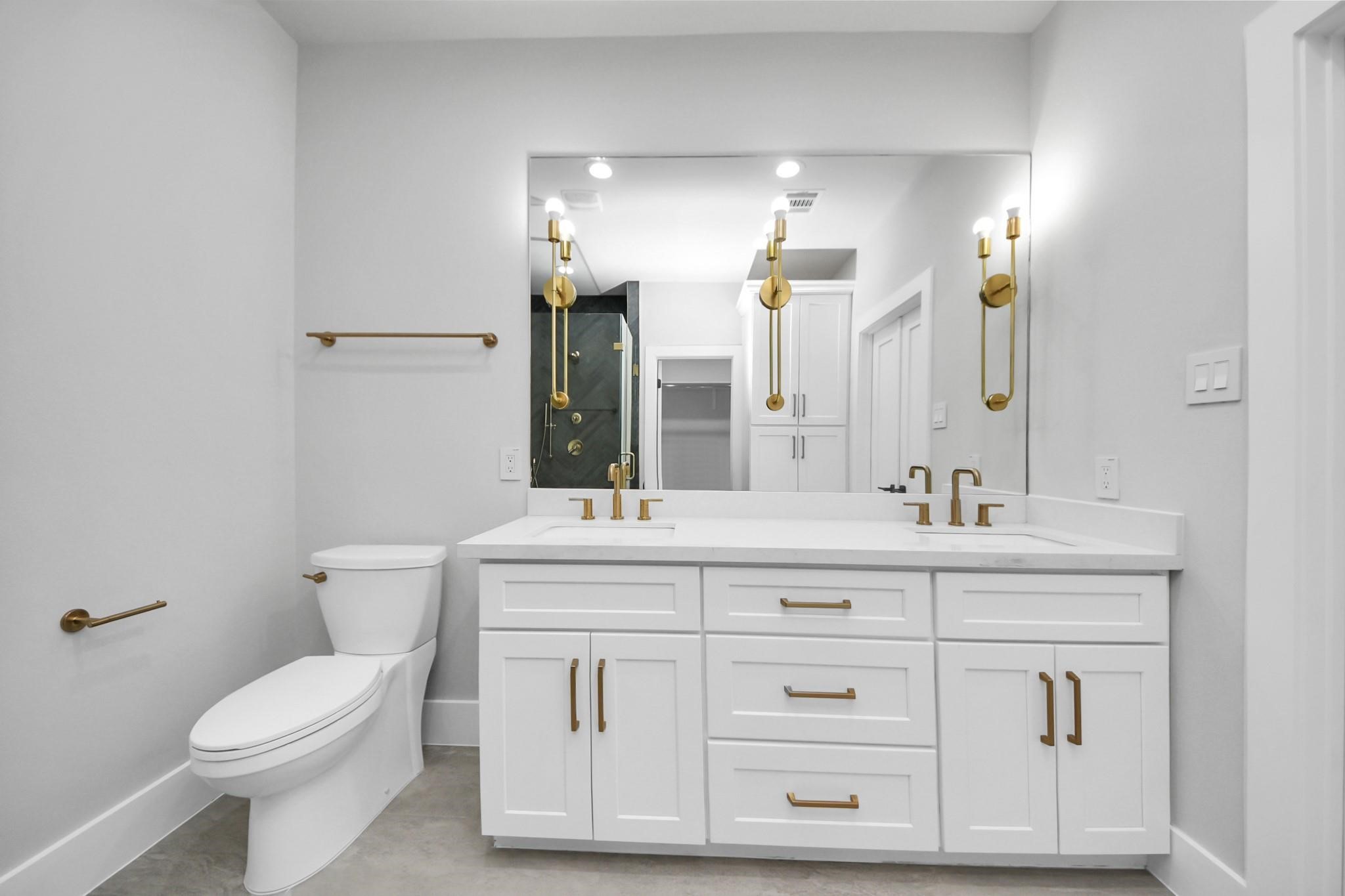 6320 Milwee Street, Unit B Houston, TX 77092 - Photo 25 of 30 a bathroom with a sink a toilet and mirror