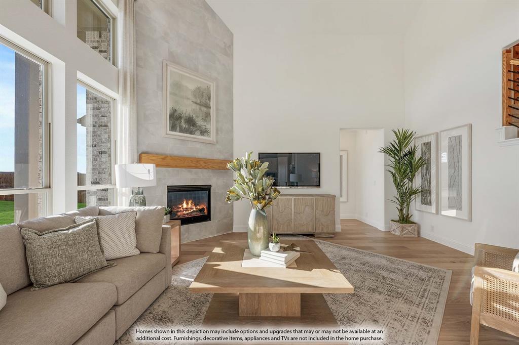 1145 Hitching Post Way Oak Point, TX 75068 - Photo 15 of 36 a living room with furniture a rug a fireplace and a large window