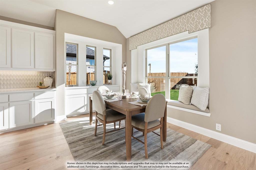 1145 Hitching Post Way Oak Point, TX 75068 - Photo 23 of 36 a view of a dining room with furniture and wooden floor
