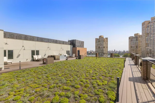 a living room with furniture a lamp and wooden floor