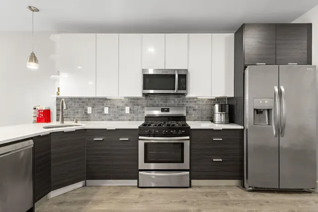 a kitchen with a sink stove and refrigerator