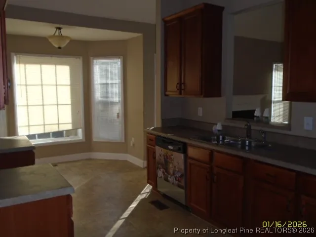 a bathroom with a granite countertop sink a mirror and a bathtub