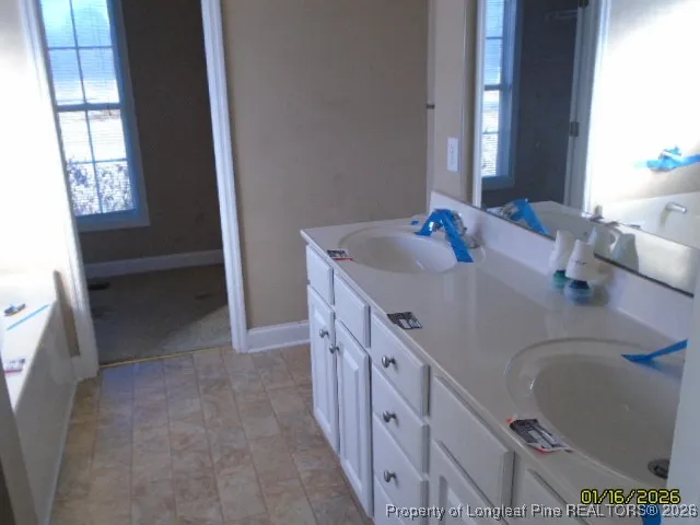 a bathroom with a double vanity sink and a mirror