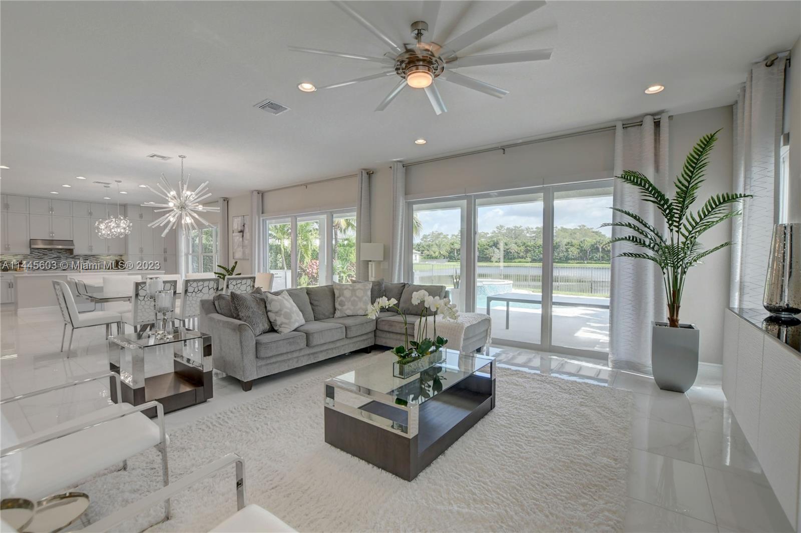 11655 Windy Frst Way Boca Raton, FL 33498 - Photo 11 of 69 a living room with furniture and a large window