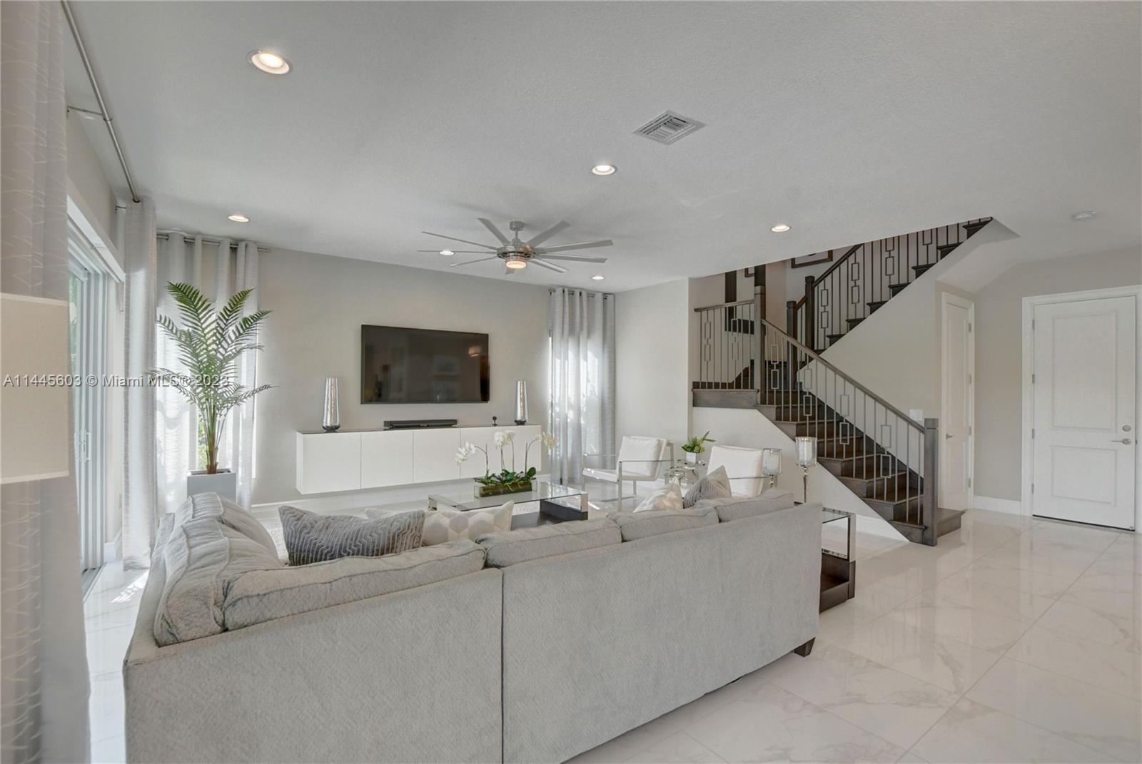 11655 Windy Frst Way Boca Raton, FL 33498 - Photo 14 of 69 a living room with furniture and a flat screen tv