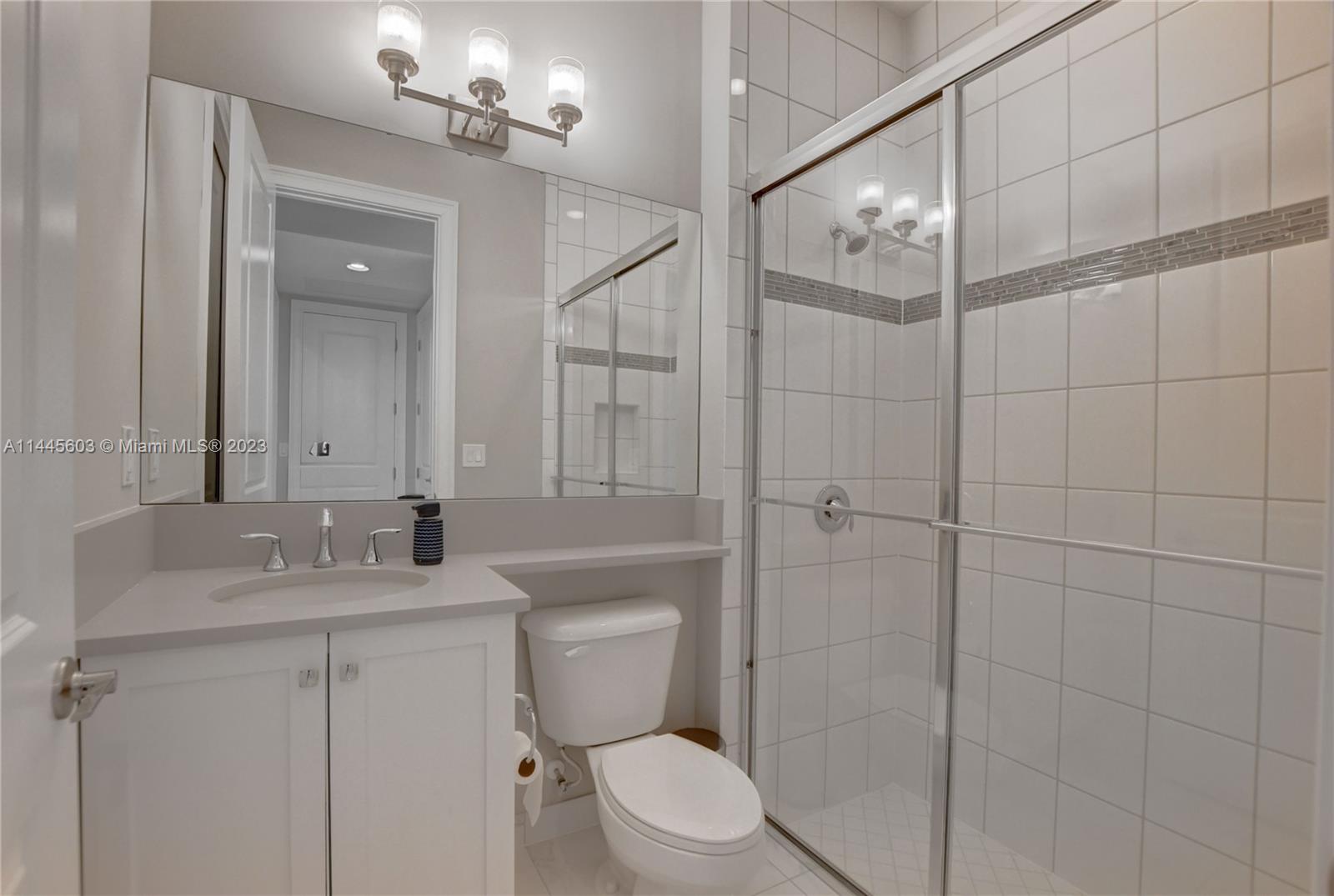 11655 Windy Frst Way Boca Raton, FL 33498 - Photo 26 of 69 a bathroom with a sink toilet vanity and shower