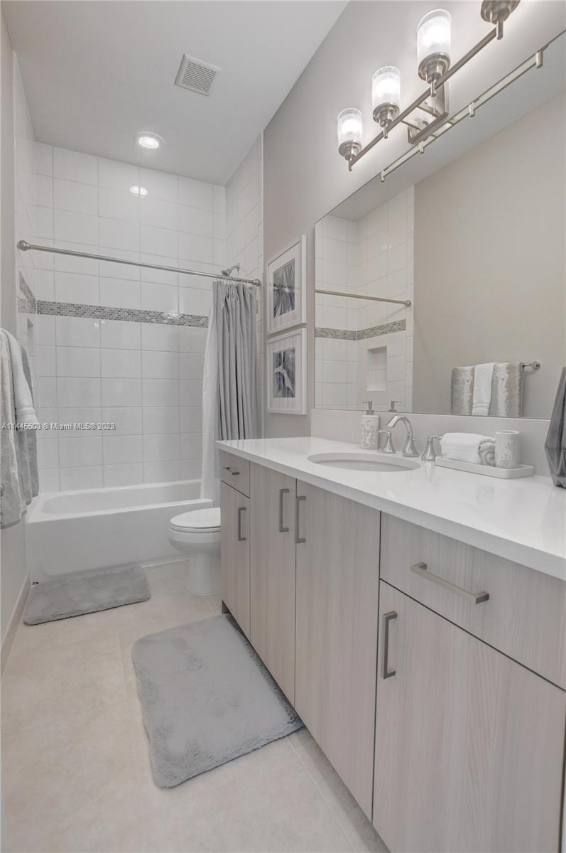 11655 Windy Frst Way Boca Raton, FL 33498 - Photo 28 of 69 a bathroom with a double vanity sink a toilet and shower