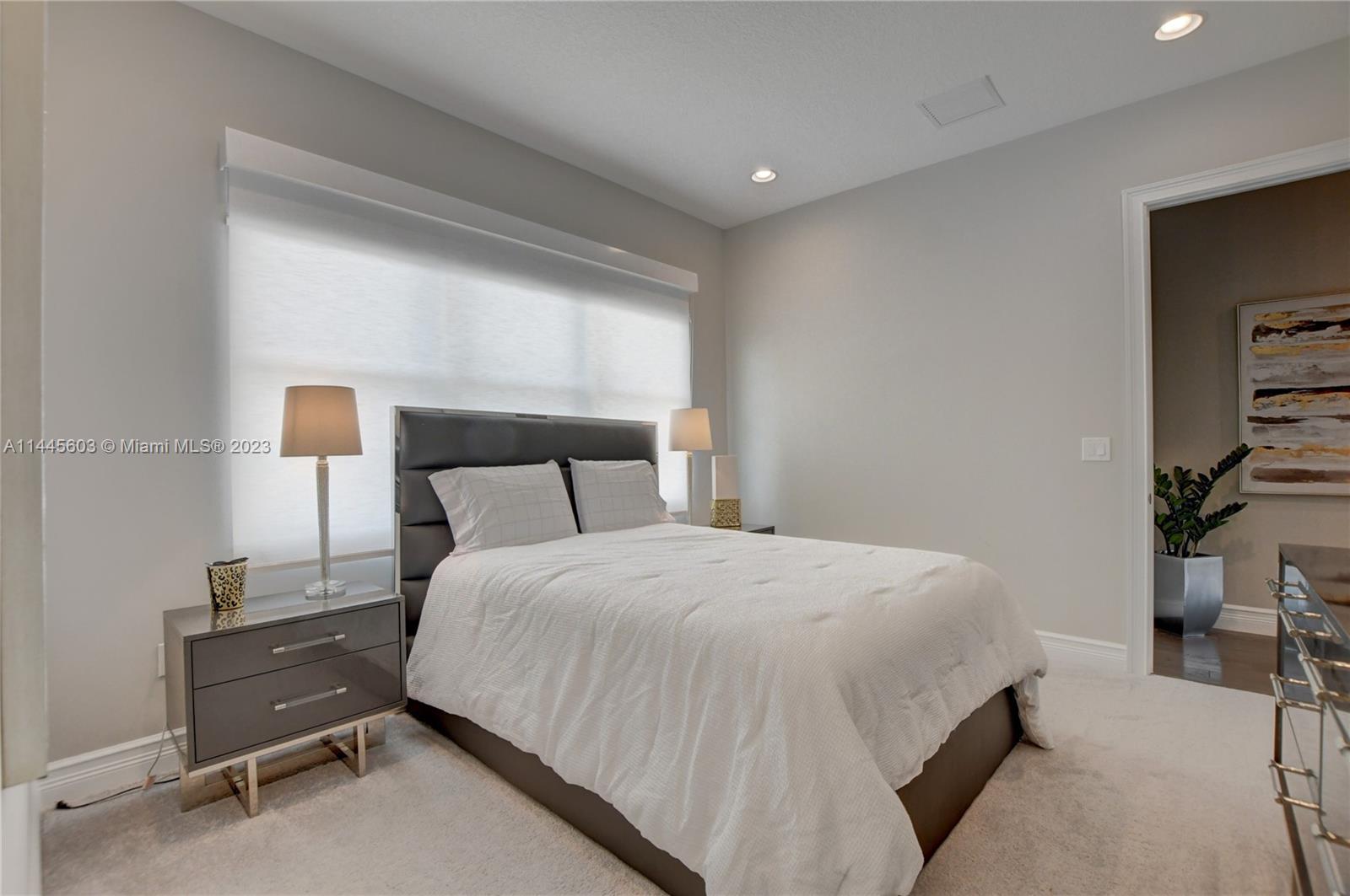 11655 Windy Frst Way Boca Raton, FL 33498 - Photo 34 of 69 a bedroom with a bed and a night stand