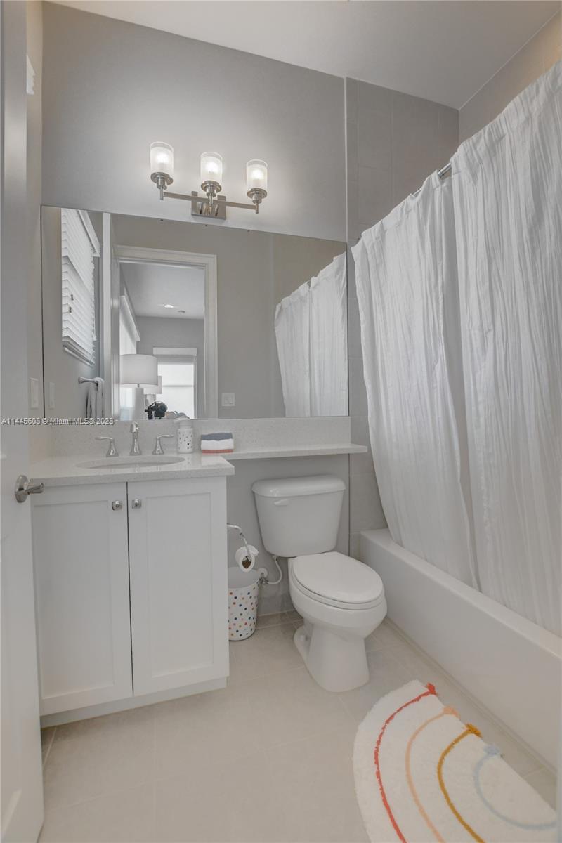 11655 Windy Frst Way Boca Raton, FL 33498 - Photo 43 of 69 a bathroom with a toilet sink and mirror