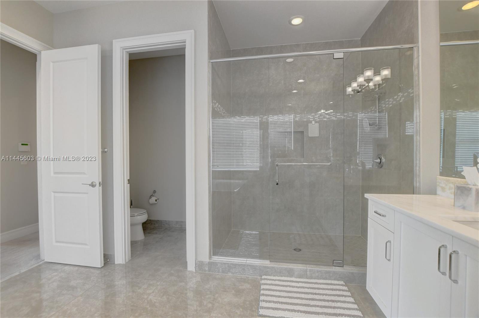 11655 Windy Frst Way Boca Raton, FL 33498 - Photo 47 of 69 a bathroom with a shower sink and toilet