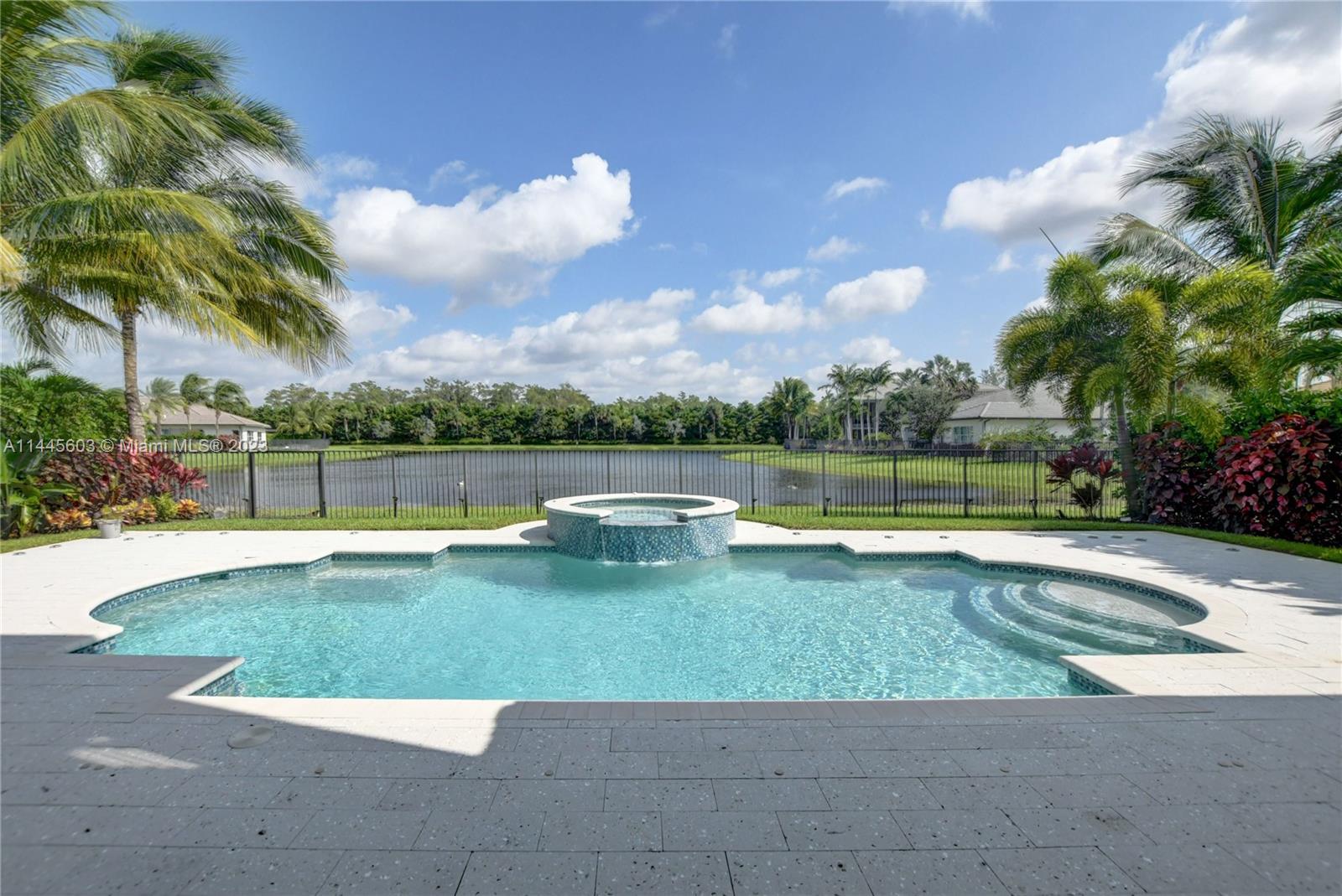 11655 Windy Frst Way Boca Raton, FL 33498 - Photo 52 of 69 a view of a swimming pool with a yard