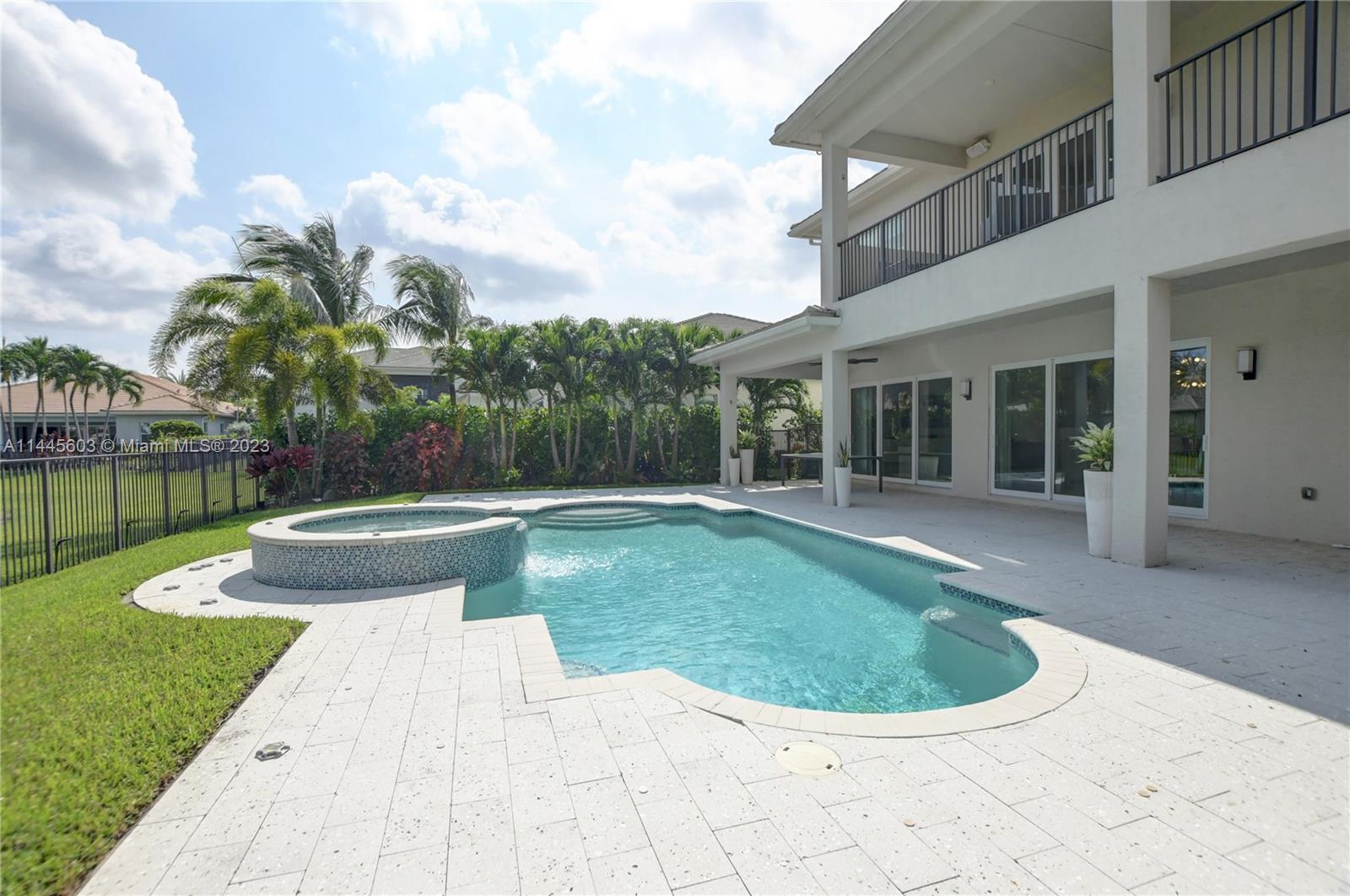 11655 Windy Frst Way Boca Raton, FL 33498 - Photo 55 of 69 a view of a house with swimming pool and view of a garden