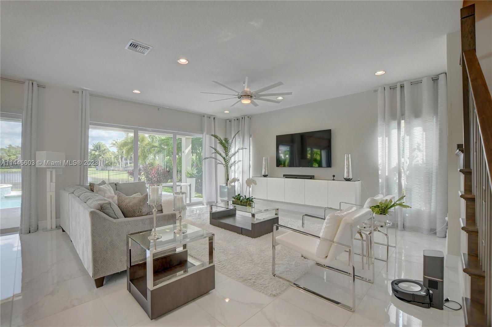 11655 Windy Frst Way Boca Raton, FL 33498 - Photo 10 of 69 a living room with furniture and a flat screen tv