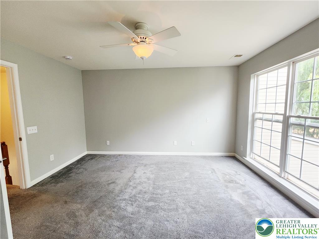 8513 Gateway Road Breinigsville, PA 18031 - Photo 28 of 45 A quiet bedroom with plush carpet and ample natural light from large pane windows.