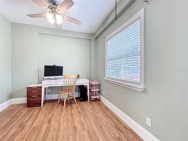 a workspace with furniture hardwood and a window