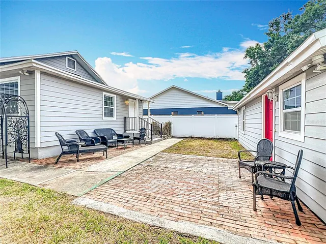 a view of a house with swimming pool and sitting area