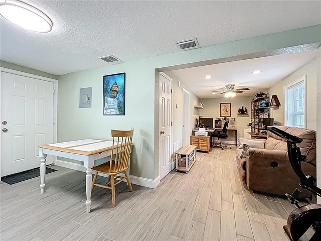 a room with furniture a wooden floor and a window