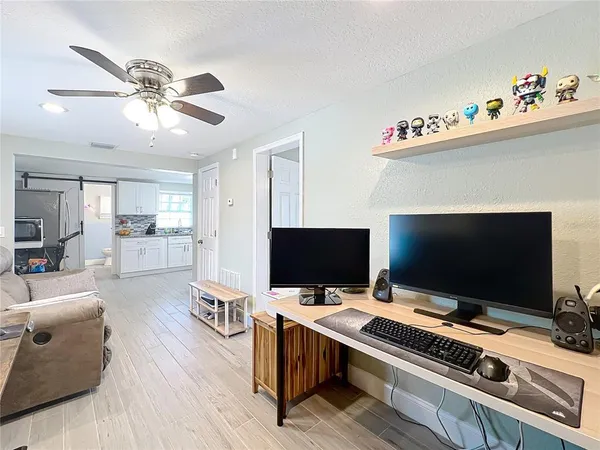 a kitchen with granite countertop white cabinets and white appliances
