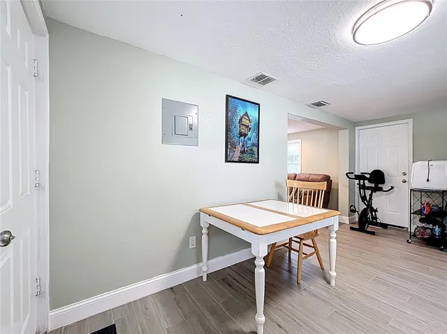 a view of a room with furniture and wooden floor
