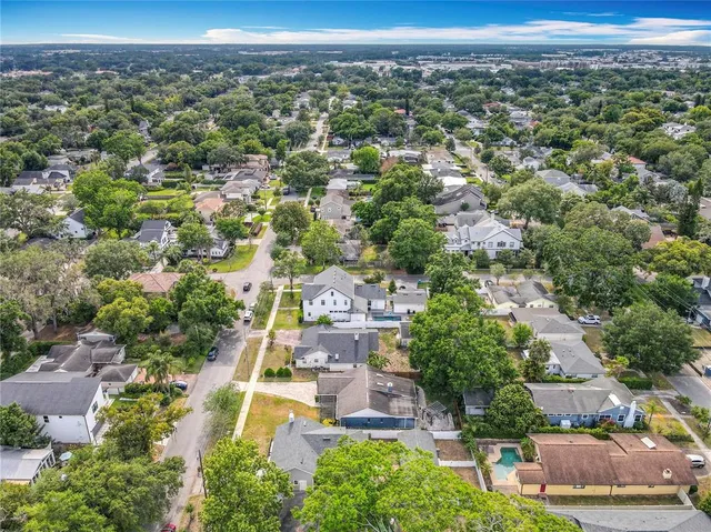an aerial view of residential houses with outdoor space and parking