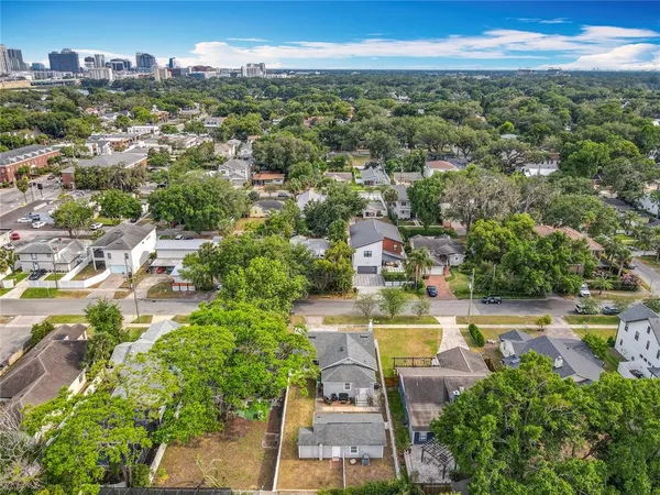 an aerial view of residential houses with outdoor space and parking