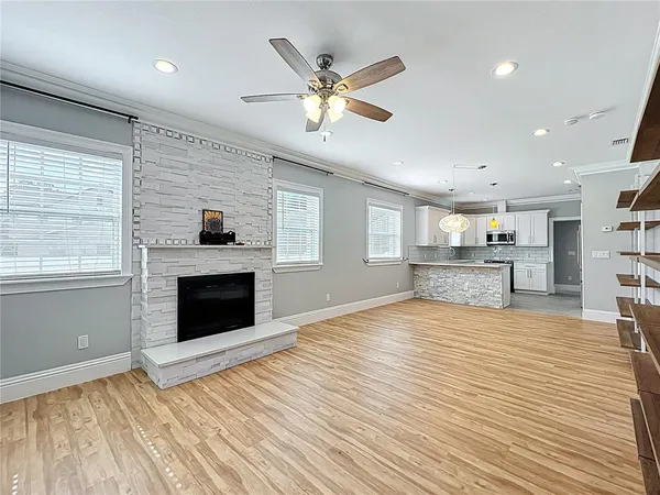 a kitchen with cabinets stainless steel appliances a sink and a window