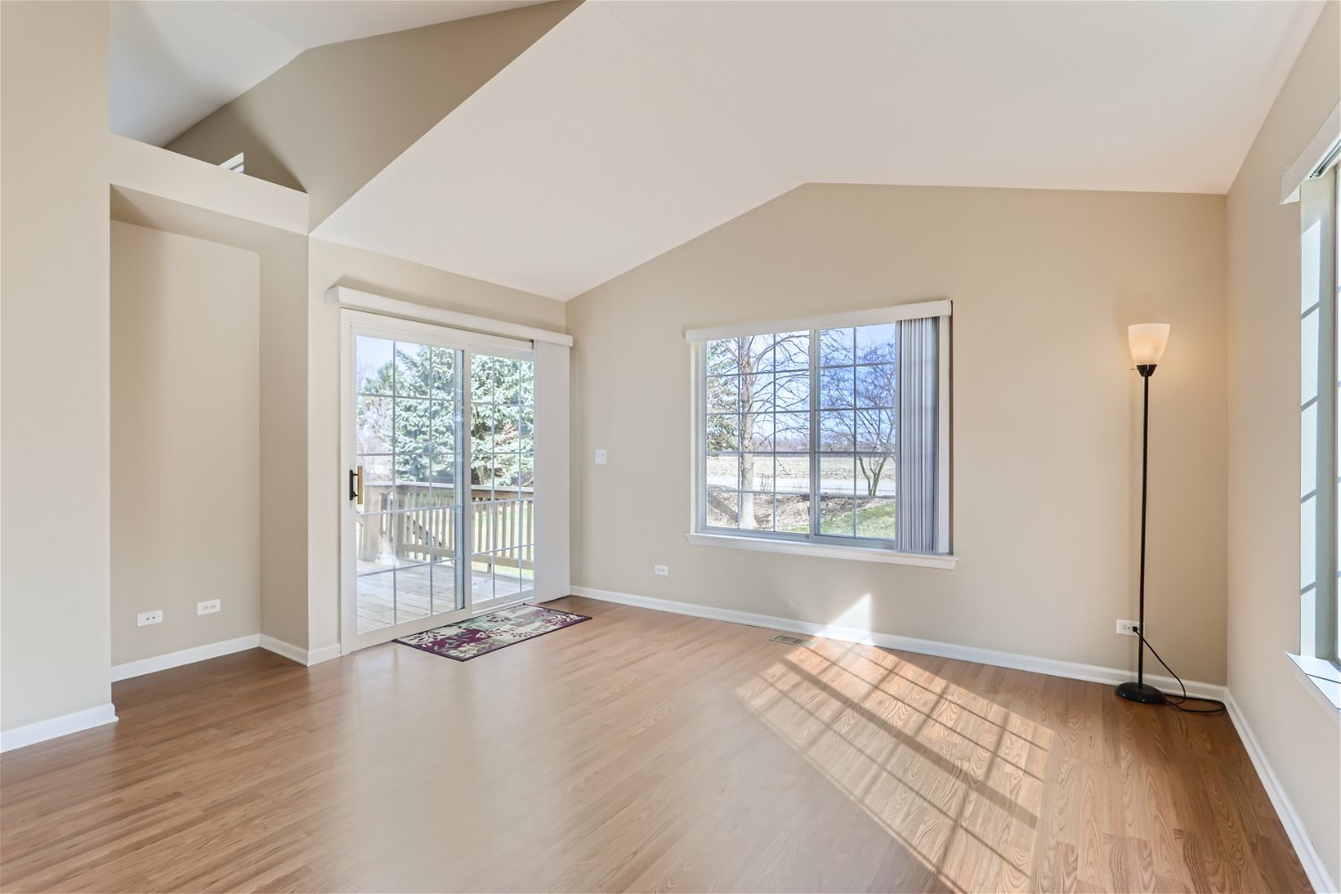 1840 Beachview Road Pingree Grove, IL 60140 - Photo 2 of 28 a view of an empty room with a window and wooden floor