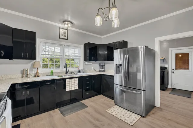 a kitchen with stainless steel appliances a sink stove and refrigerator