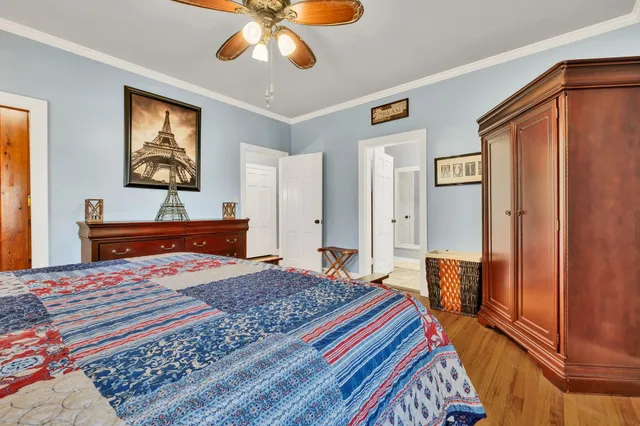 a bedroom with a bed and a chandelier