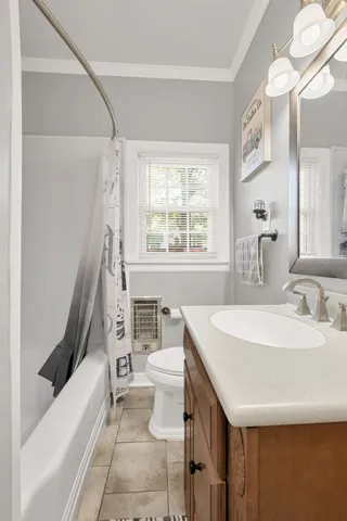 a bathroom with a sink a toilet a vanity and a bathtub