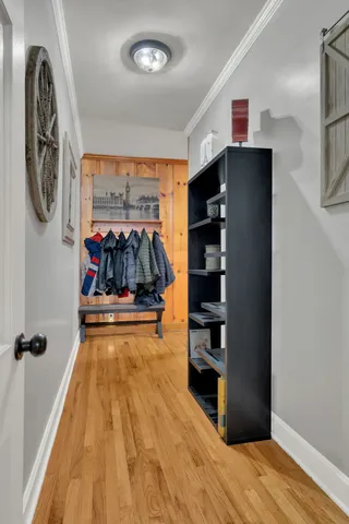 a view of a living room with entryway and wooden floor