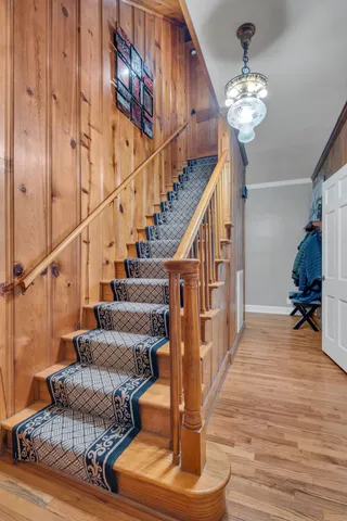 a view of entryway and hall with wooden floor