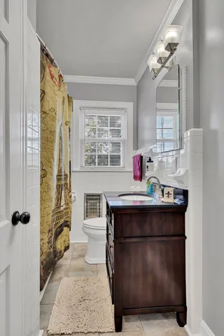 a room with a table chairs and chandelier