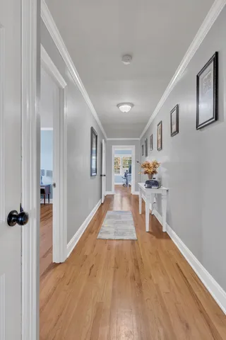 a view of a hallway view with wooden floor and staircase