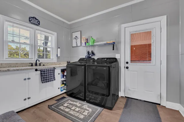 a view of kitchen with windows and white cabinets