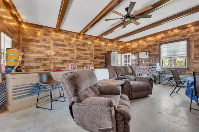 a work room with furniture and a floor to ceiling window