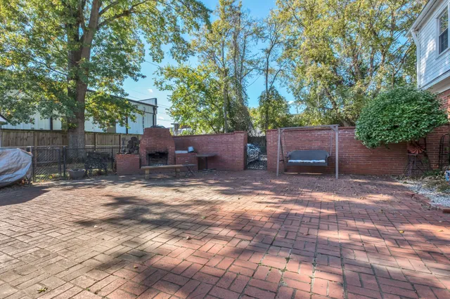 a backyard of a house with fire pit and furniture