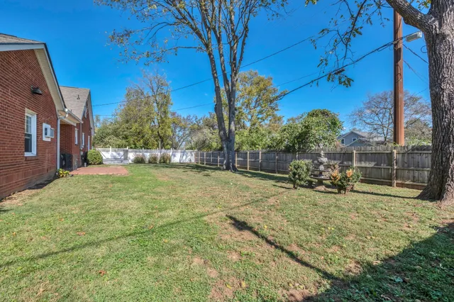a view of a yard with basketball court