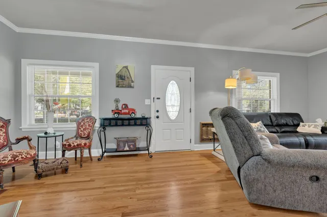 a living room with furniture and a wooden floor